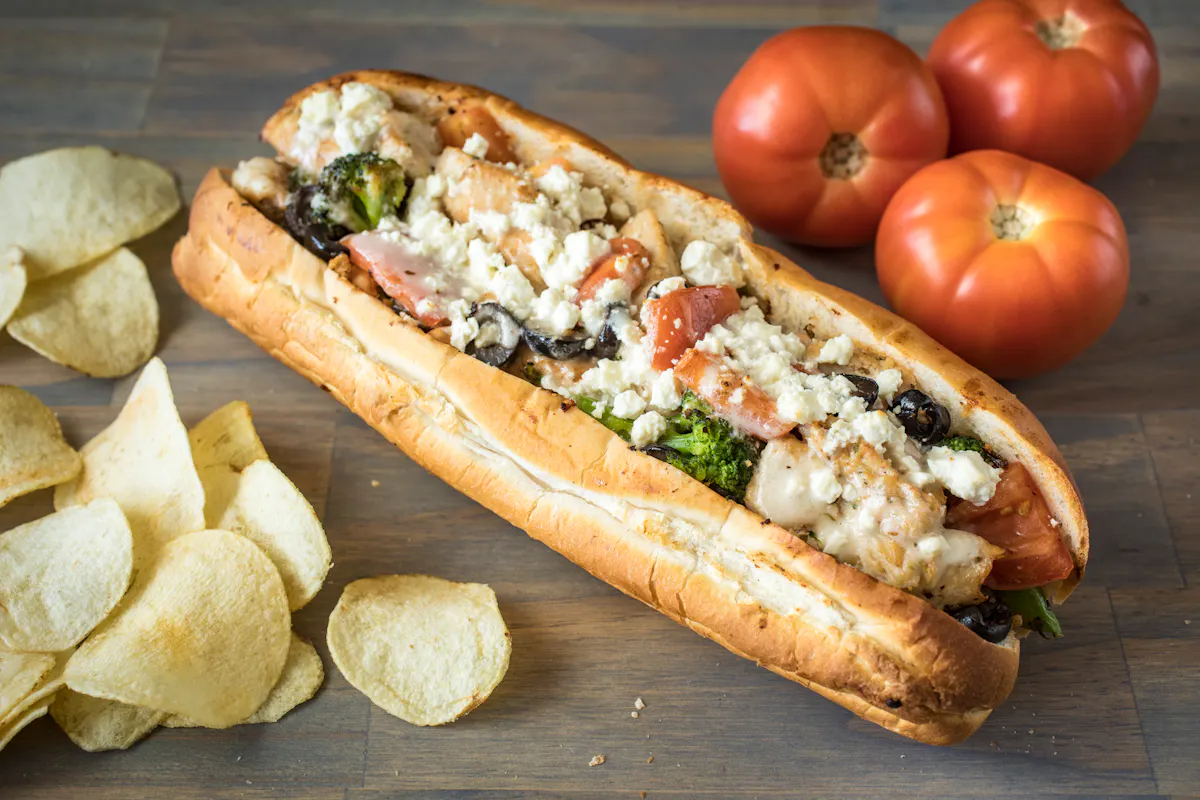 a hot dog on a wooden cutting board